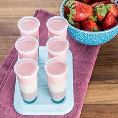 Pop cups and a bowl of strawberries