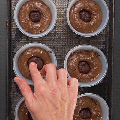 Ganache balls being put into the middle of the cake batter