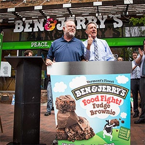 Ben & Jerry's co-founder stands behind a large pint of Food Fight Fudge Brownie, Burlington, VT, 2014